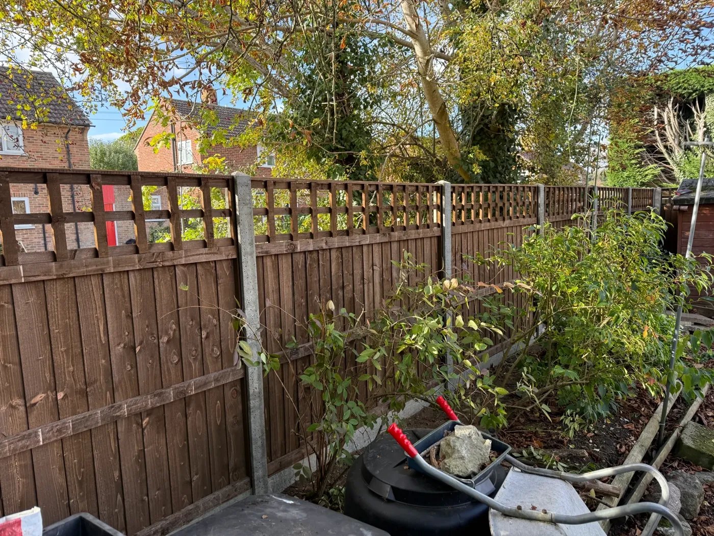 Lap panel fencing with concrete posts and gravel boards